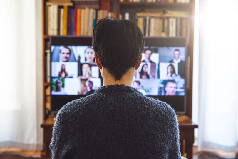 A person looking at an online meeting with 12 or more people on the screen. This signifies creating a community for your online learning environment.
